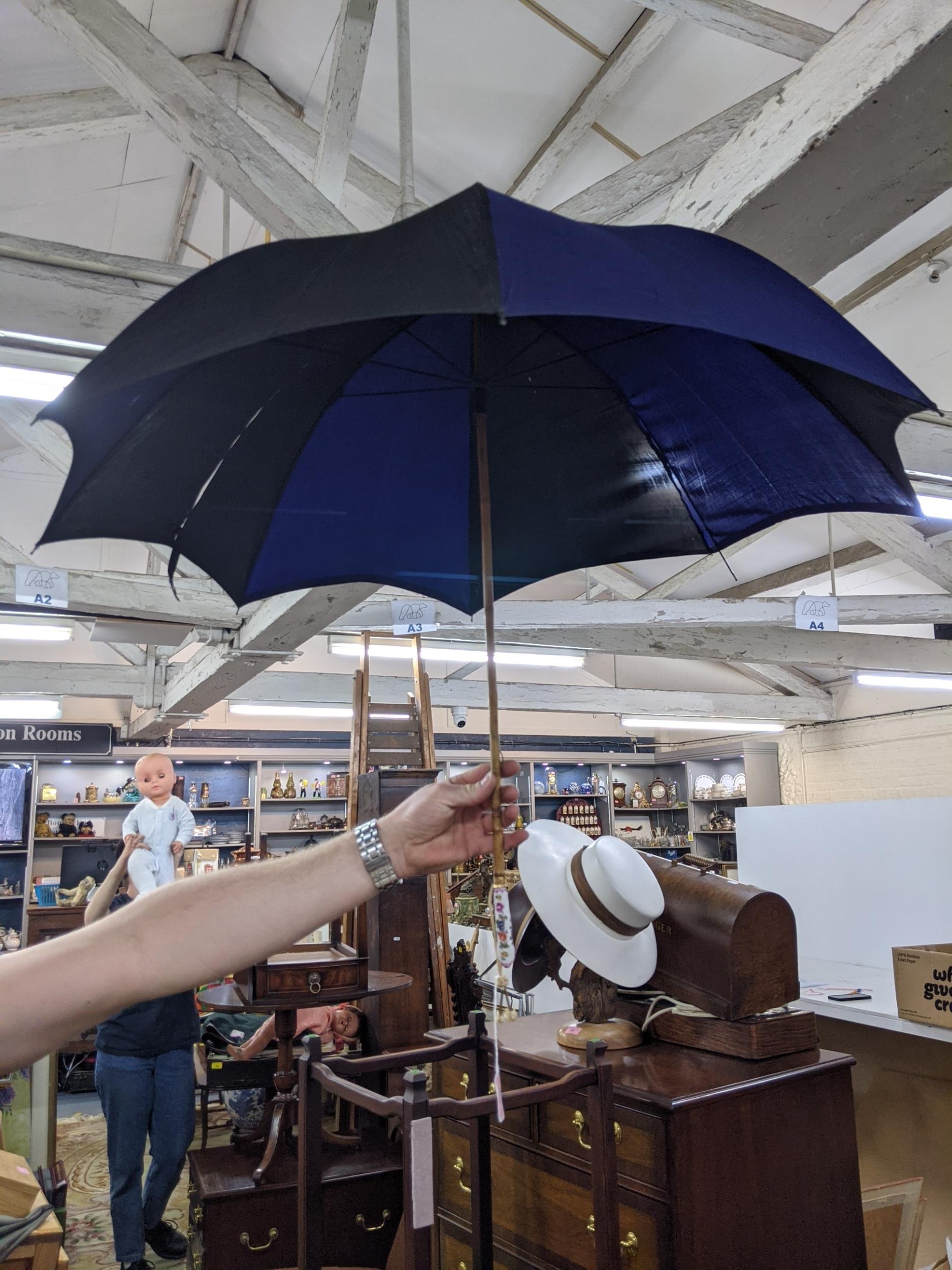 A mid 20th Century cane handled umbrella in black and navy with painted porcelain handle and - Image 2 of 4