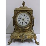 A late 19th century French gilt metal 8 day mantle clock having a white enamel signed dial and