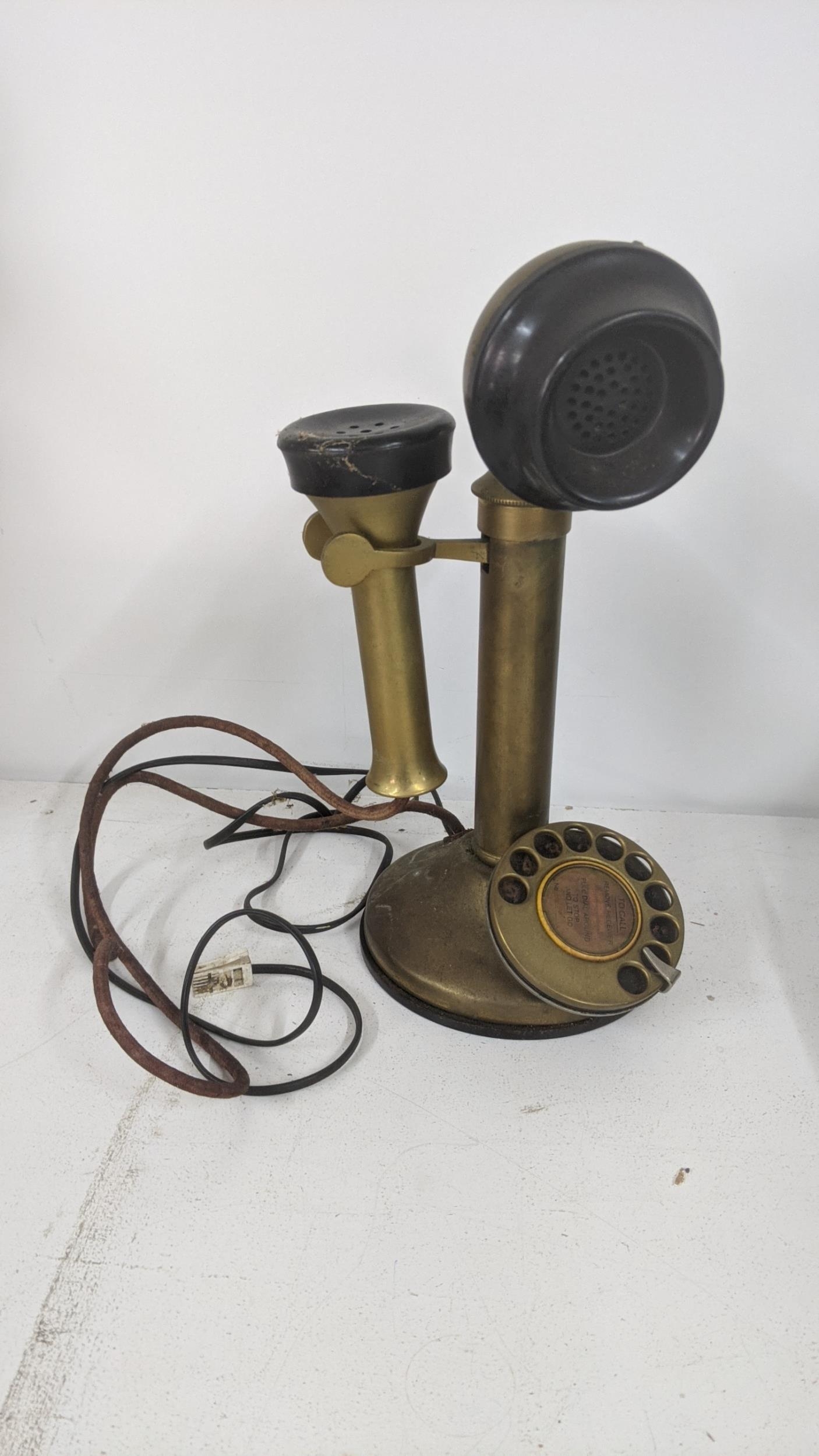 An early to mid 20th century brass candlestick telephone Location: If there is no condition report