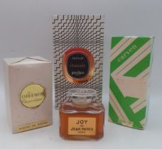 Four vintage fragrances comprising a full bottle of Joy de Jean Patou, a sealed bottle of Jacques