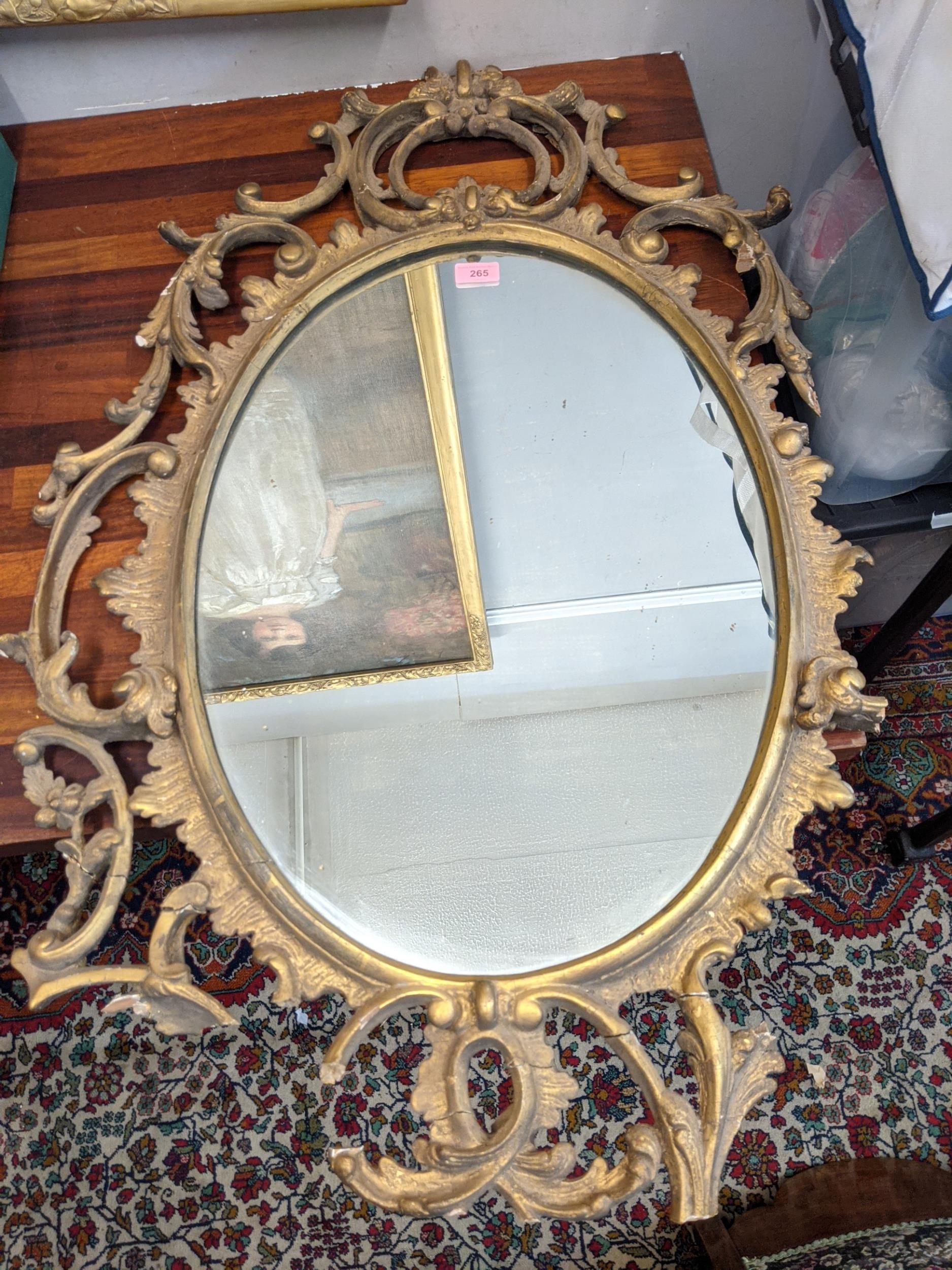 A late 19th /early 20th century oval gilt wall mirror ornately and symmetrically decorated in - Image 2 of 9