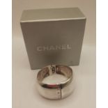 Chanel-A wide silver cuff bangle branded towards the opening and to the hinge, stamped 925 with grey