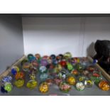 A collection of glass paperweights to include Chinese flower weights, and others Location: If