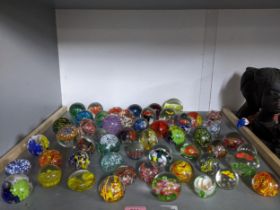 A collection of glass paperweights to include Chinese flower weights, and others Location: If