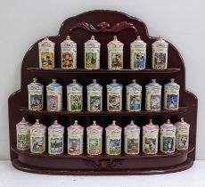 A Lenox Walt Disney fine porcelain jar collection housed within a mahogany wall hanging three tier