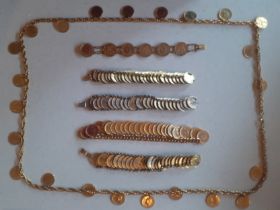 A quantity of vintage Jewelcraft and other gold tone coin chains comprising a necklace and bracelets