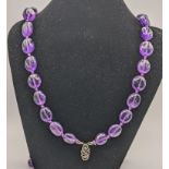 An amethyst coloured beaded necklace with a silver clasp inset with diamante paste stones Location: