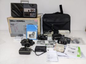 A selection of digital and film cameras to include a Nikon FG-20, Olympus A2-300 Super Zoom, and