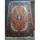 A silk Heriz rug with a central medallion on a copper coloured ground, 150cm x 100cm Location: If