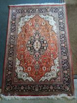 A silk Heriz rug with a central medallion on a copper coloured ground, 150cm x 100cm Location: If