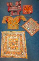 A group of traditional hand embroidered Indian decorative items to include a Dandiya dance blouse, a