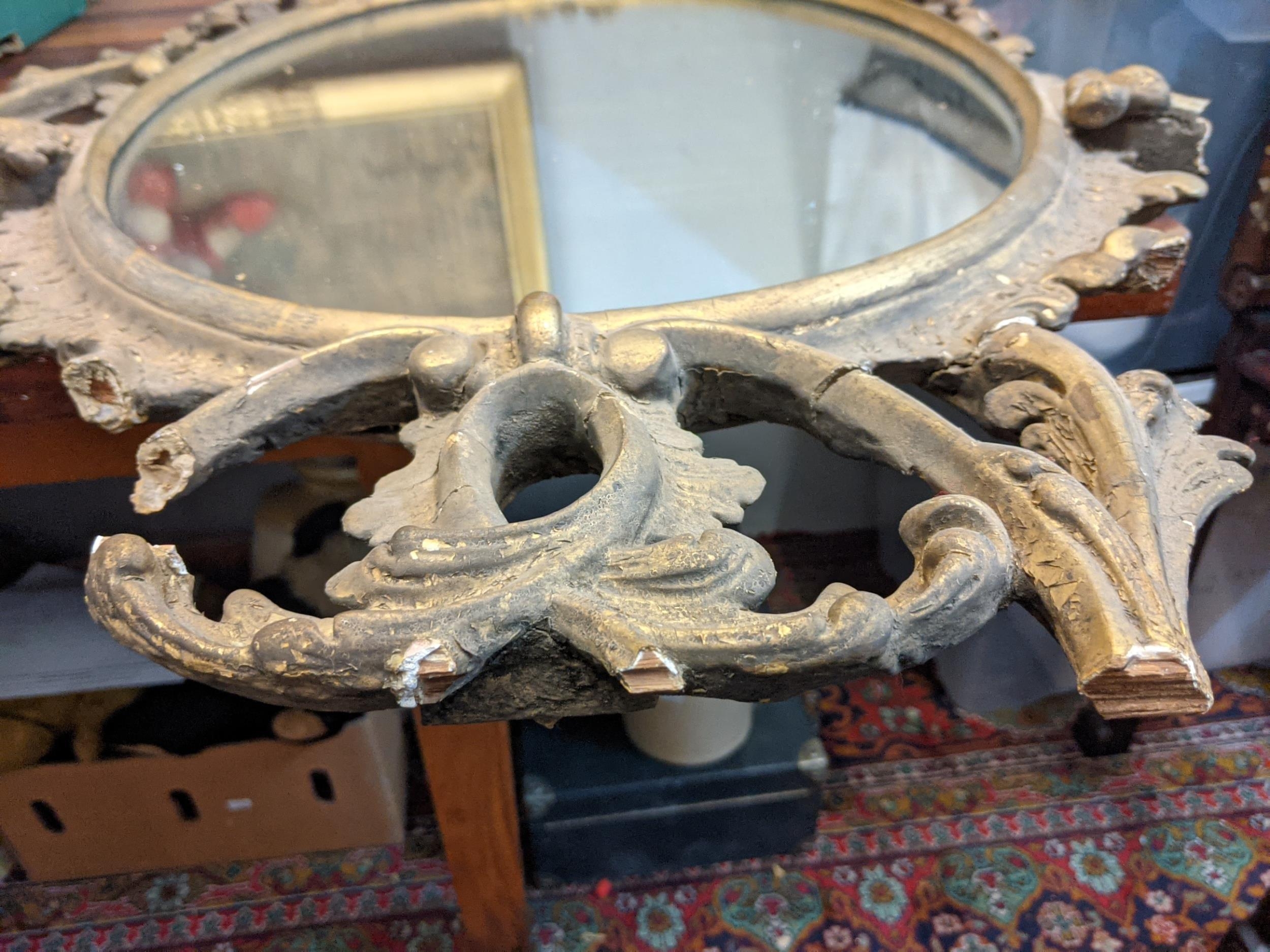 A late 19th /early 20th century oval gilt wall mirror ornately and symmetrically decorated in - Image 7 of 9