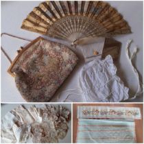 A 19th Century mother of pearl wand and cream silk fan decorated with embroidery, sequins and images