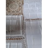 A group of 6 early to mid 20th Century white cotton and cream tablecloths. Location: