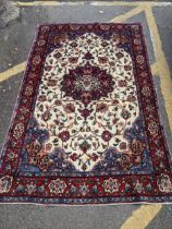 A Kashan rug with a central medallion on a red ground, 195cm x 135cm Location: If there is no