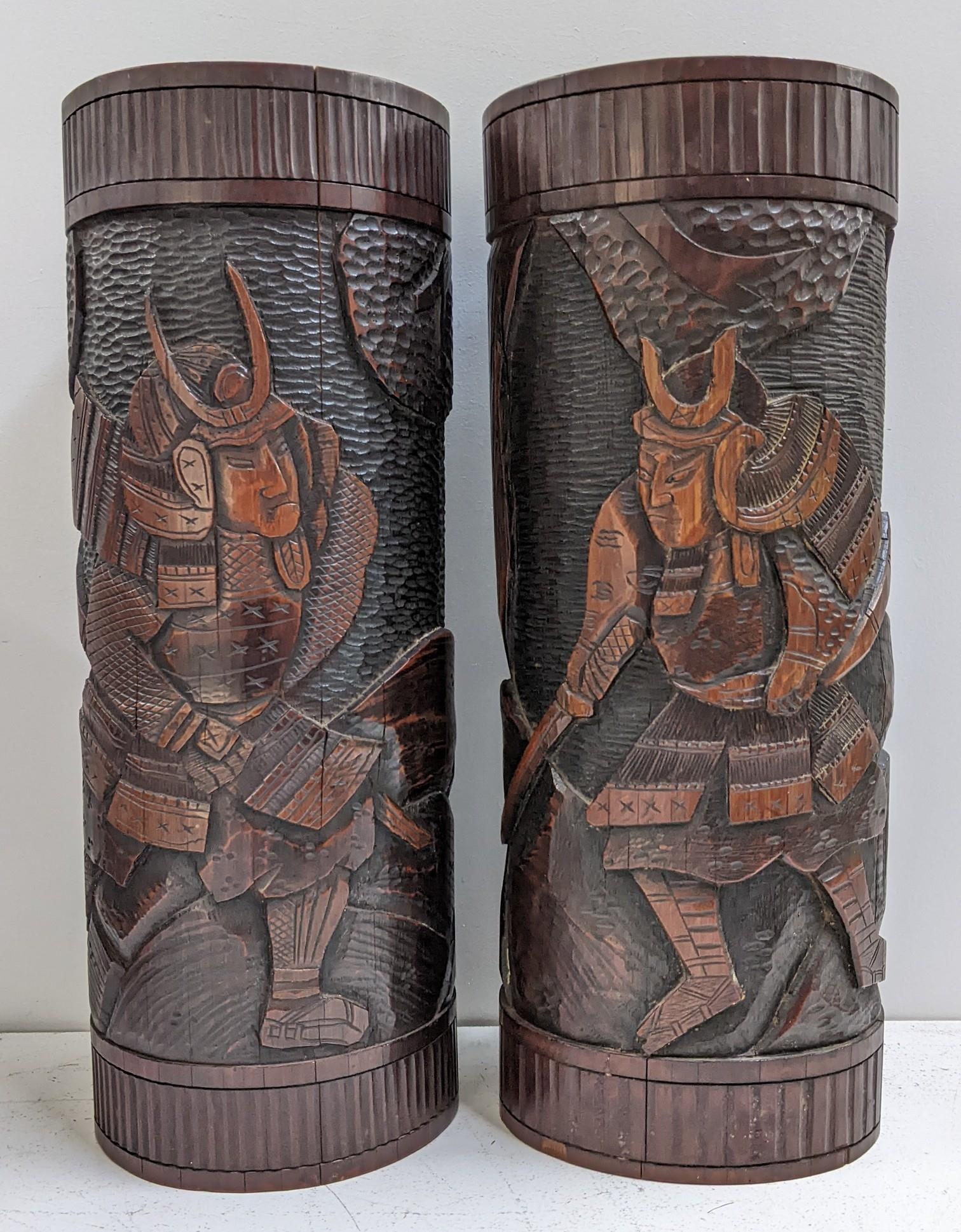 A pair of Chinese bamboo carved brush pots, carved with scenes of warriors, 30cm h x 12.5cm w