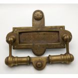 A Victorian brass letter rack with an integrated door knocker Location: CAB If there is no condition