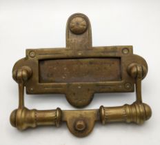 A Victorian brass letter rack with an integrated door knocker Location: CAB If there is no condition