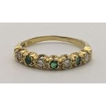 An 18ct gold ring set with diamonds and emeralds, 3g Location: If there is no condition report