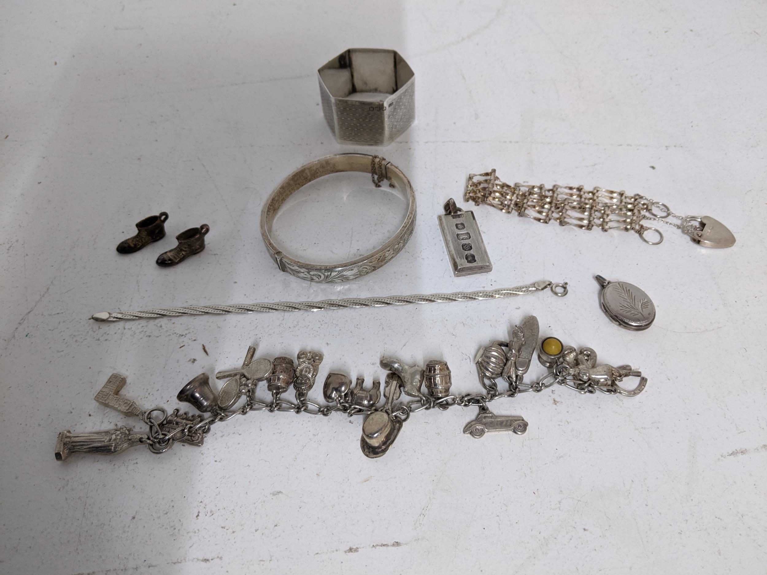 A mixed group of silver jewellery to include a charm bracelet with approx 21 silver and white