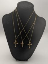 Three gold cross pendants tested as 9ct gold to include one set with a diamond all on 9ct gold