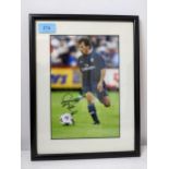 A framed and glazed autographed photo depicting Gianfranco Zola in Chelsea FC football team strip,