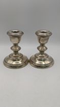 A pair of silver WI Broadway and Co weighted candlesticks hallmarked Birmingham 1965 Location: If