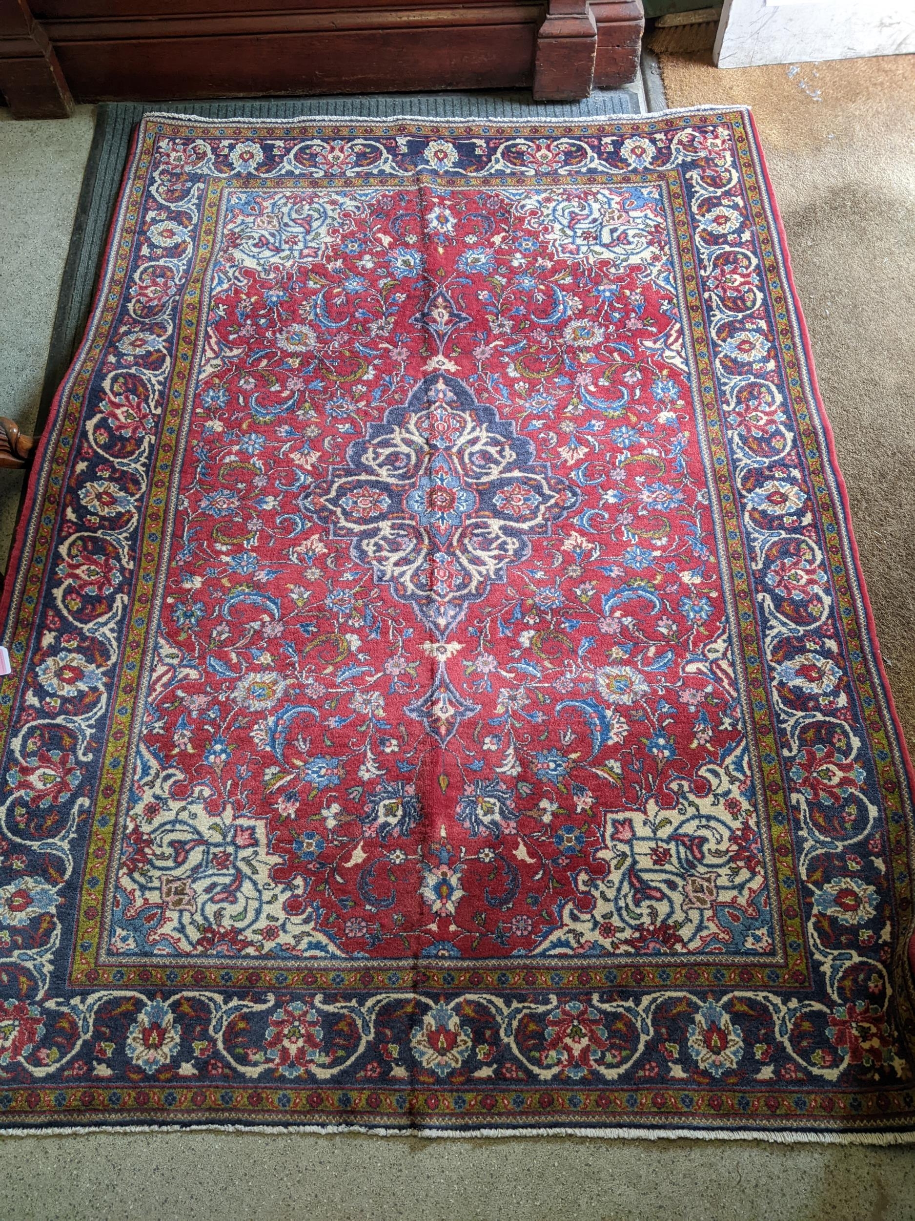 An Isfahan rug with a central medallion on a cream coloured ground 205cm x 131cm Location:LAB If