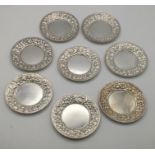 Eight Theordore B. Starr sterling silver pin dishes, with embossed boarders, total weight 230.5g