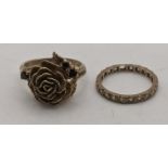 A 9ct gold eternity ring and a 9ct gold ring fashioned as a flower set with three garnets 7g