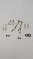 Five pairs of 9ct gold stud earrings together with two yellow metal pairs of earrings tested as