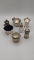 Silver to include various condiment pots, two pepper pots, a crystal cut glass scent bottle and