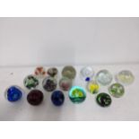 A selection of glass paperweights to include two signed Adam Jablonski abstract weights, a