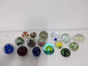 A selection of glass paperweights to include two signed Adam Jablonski abstract weights, a