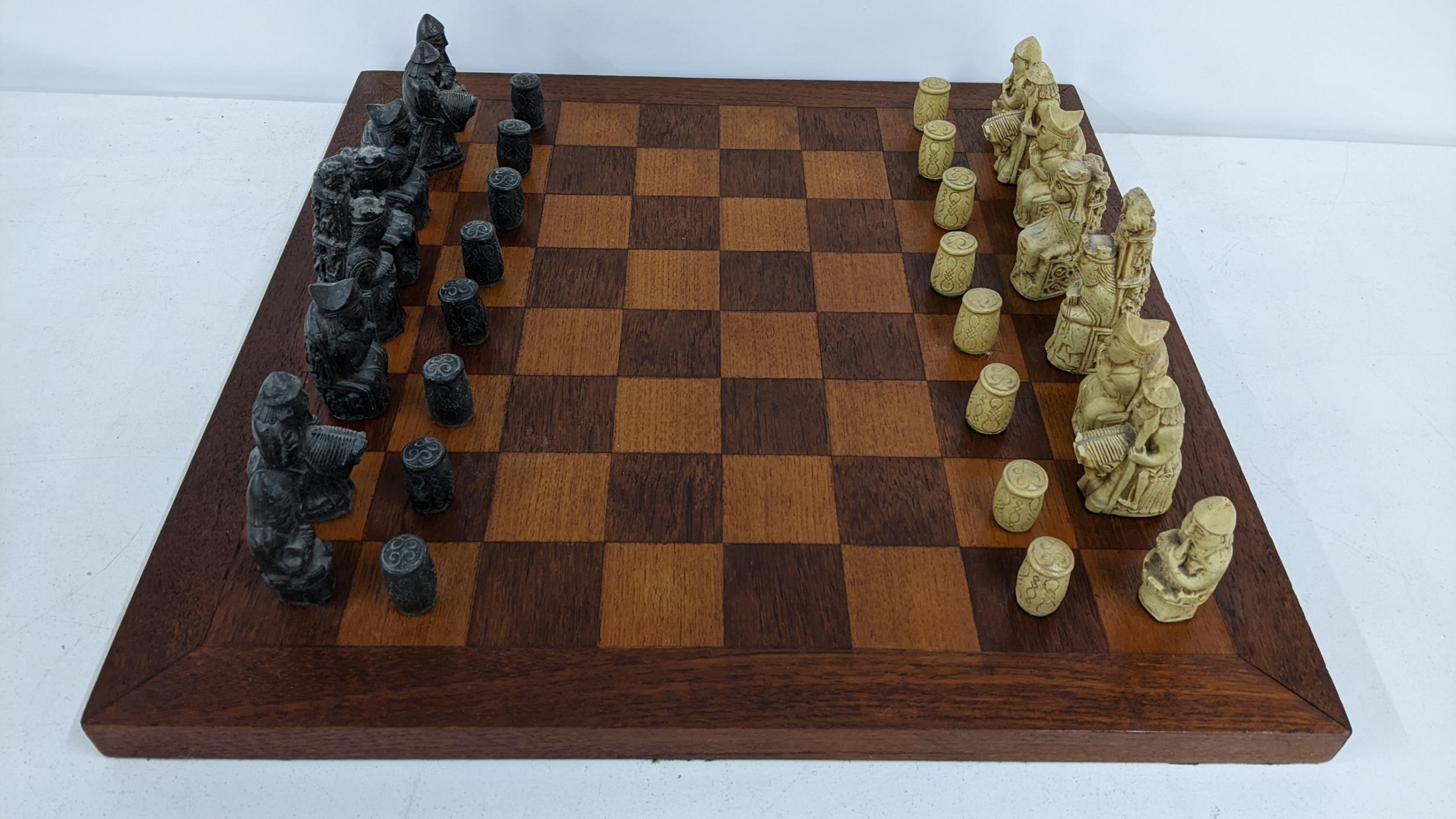 A mid/ late 20th century Resin chess set on an oak board Location: If there is no condition report
