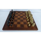 A mid/ late 20th century Resin chess set on an oak board Location: If there is no condition report