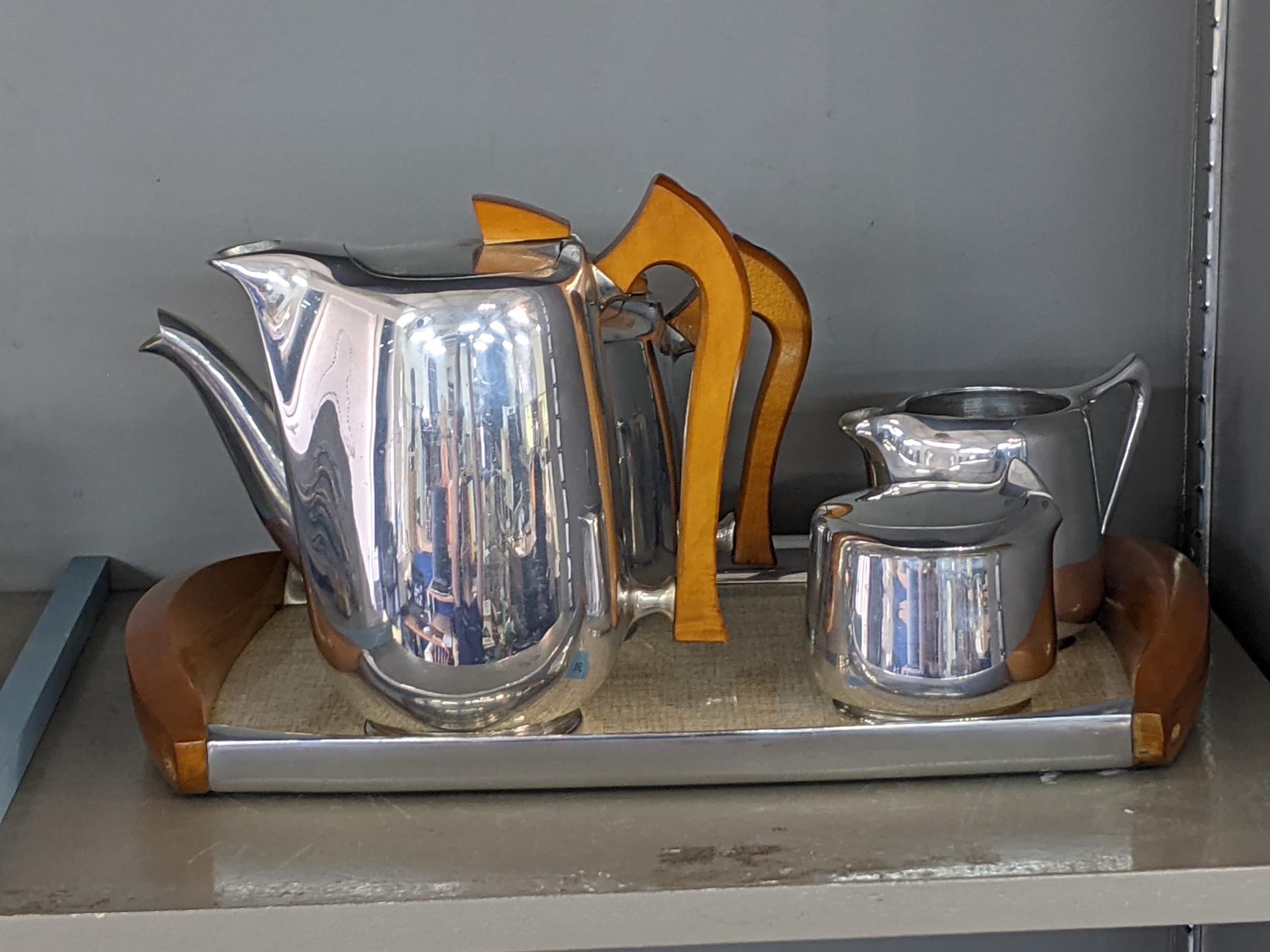 Picquot ware items to include a teapot, a coffee pot, a milk jug and a sugar bowl with a hinged