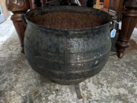 A cast iron twin handled cooking pot on a wrought iron stand A/F Location: If there is no