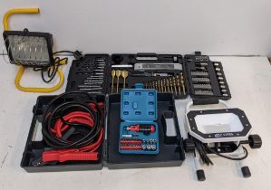 Two heavy duty security lights, a boxed set of jump leads, a screwdriver/drill set, and another