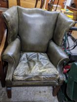 A reproduction green leather upholstered armchair on mahogany square legs and stretchers Location:
