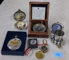 Three compasses, one boxed, the Dalvey Voyager clock in a case, a collapsible pocket dram cup in a