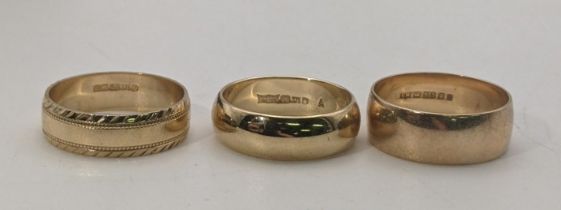 Three 9ct gold wedding bands to include one having engraved detail total weight 6.9g Location: If