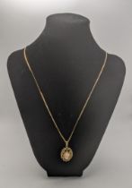 A 9ct gold necklace with a 9ct gold pendant set with a cameo 8.1g Location: If there is no condition