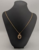 A 14ct gold and citrine pendant 4.7g on a 9ct gold necklace 8.3g Location: