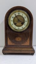 An Edwardian mahogany arched top mantel clock, the 8-day movement striking on a gong, 27.5cm h