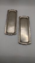 A pair of silver condiment trays with wave shaped boarders, 197.7g Location: If there is no