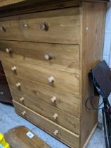 A modern pine seven drawer chest, two short and five long, bun shaped handles and feet 138cm x 111cm