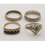 Four 9ct gold ladies rings to include an eternity band, a decorative pierced love heart ring set