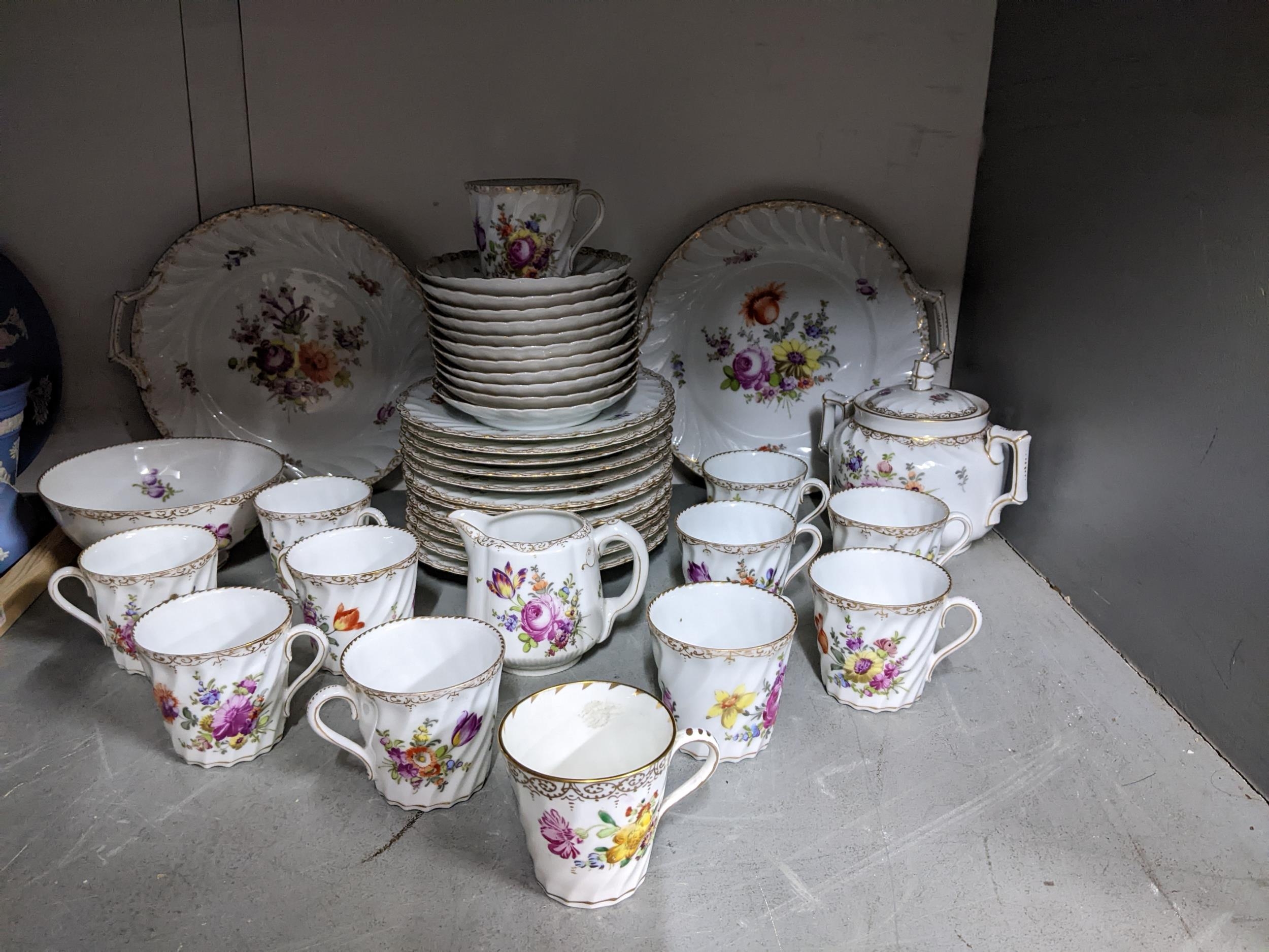 A late 19th Dresden porcelain tea set decorated with flower sprays and a gilt border, approx 41