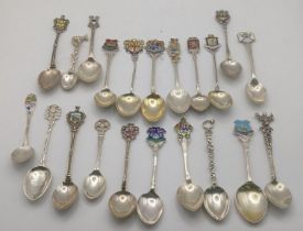 A collection of silver and white metal collectors spoons to include silver spoons decorated with